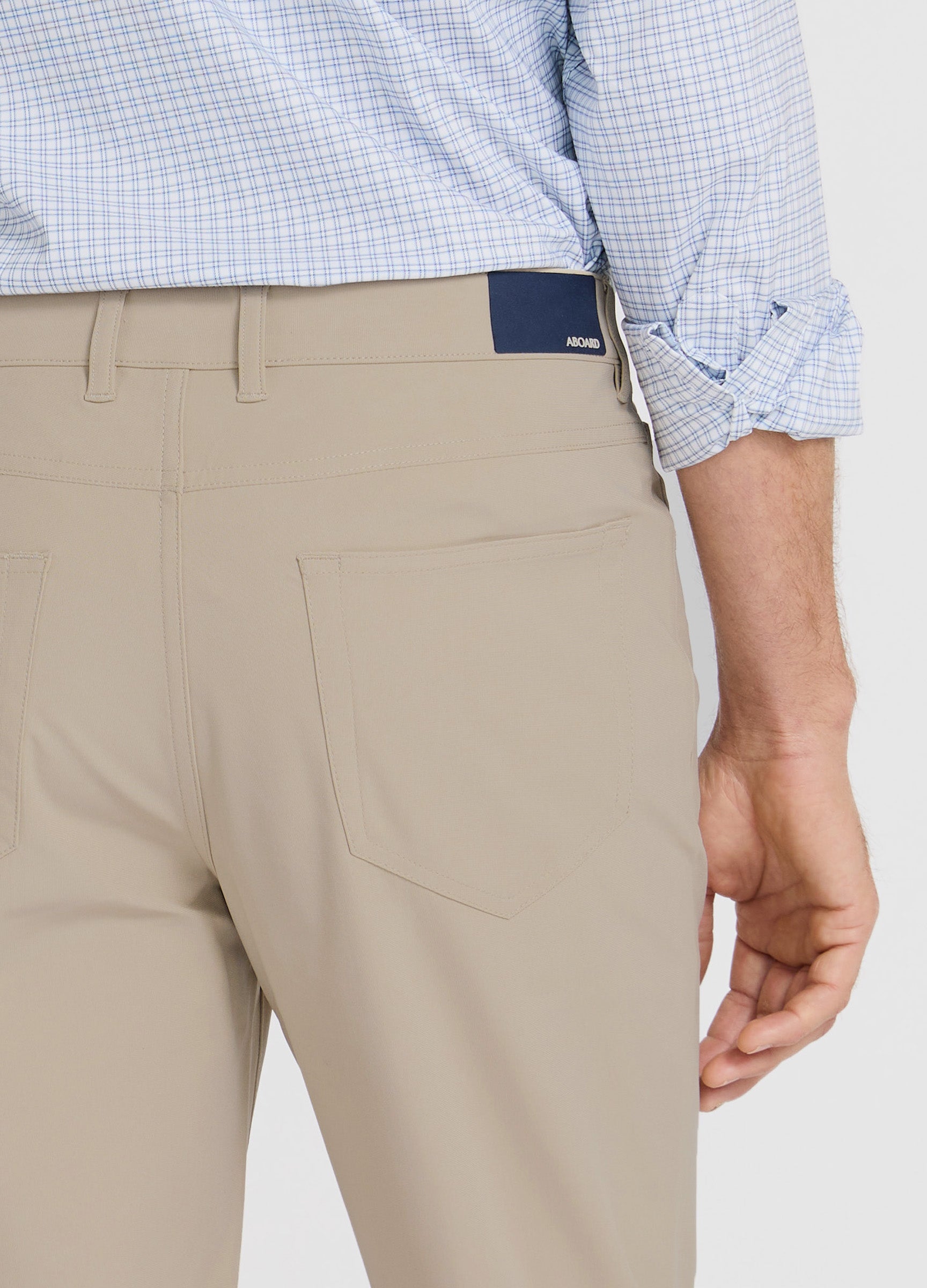 Four Seasons Travel Pant in Sand – Patch Back Pockets with Branded Patch #color_sand