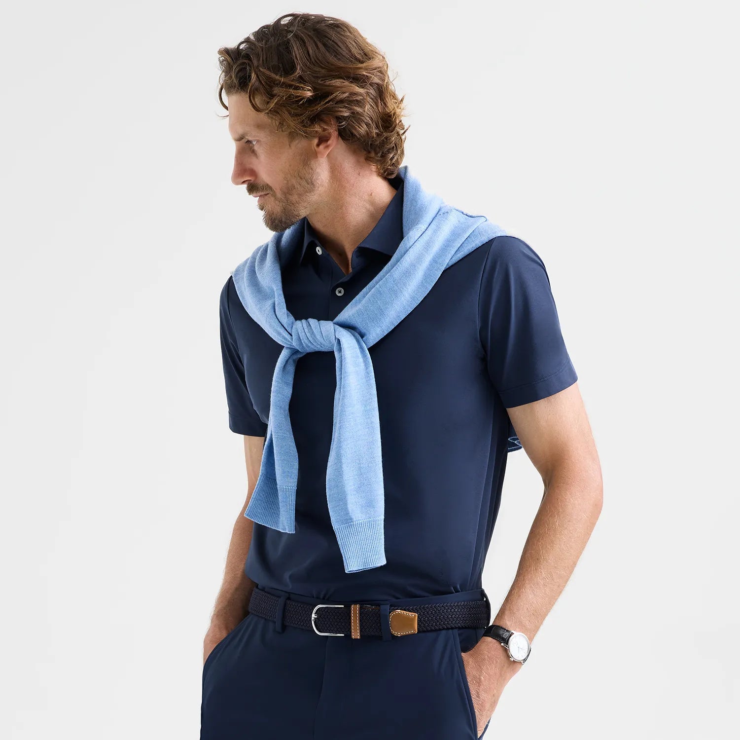 Model wearing ABOARD Como Travel Polo in Navy, featuring Polygiene StayFresh® technology to resist odors and extend wear without washing, perfect for travel.