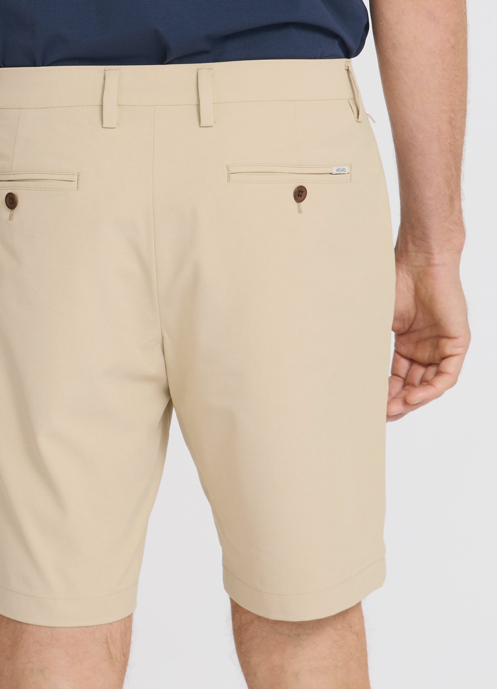 Positano Travel Chino Short in Sand – Fabric & Fit Close-Up with Luxury Corozo Nut Buttons #color_sand