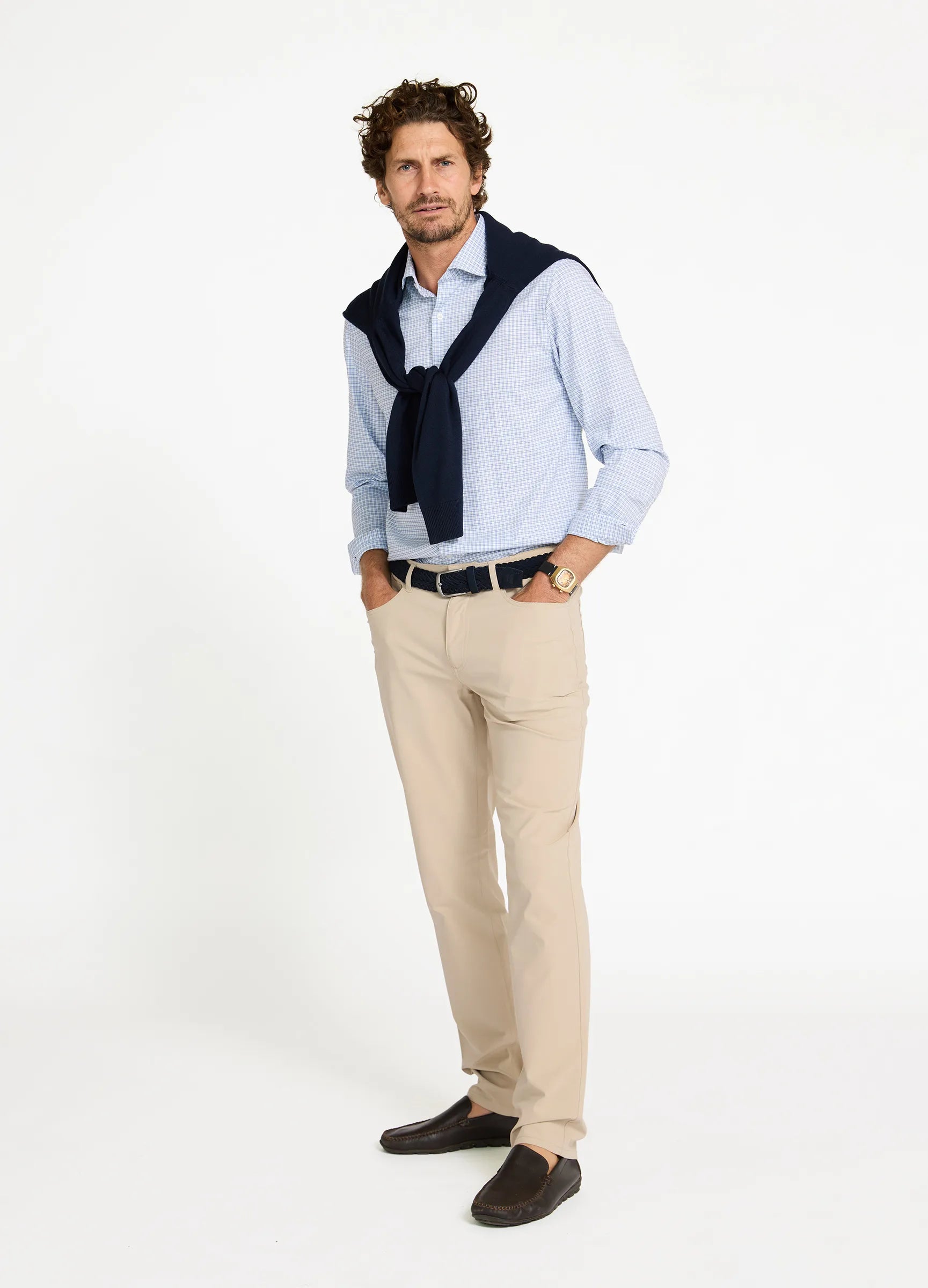 Man wearing Aboard Mayfair Check Travel Shirt with jumper and chinos — smart casual travel outfit