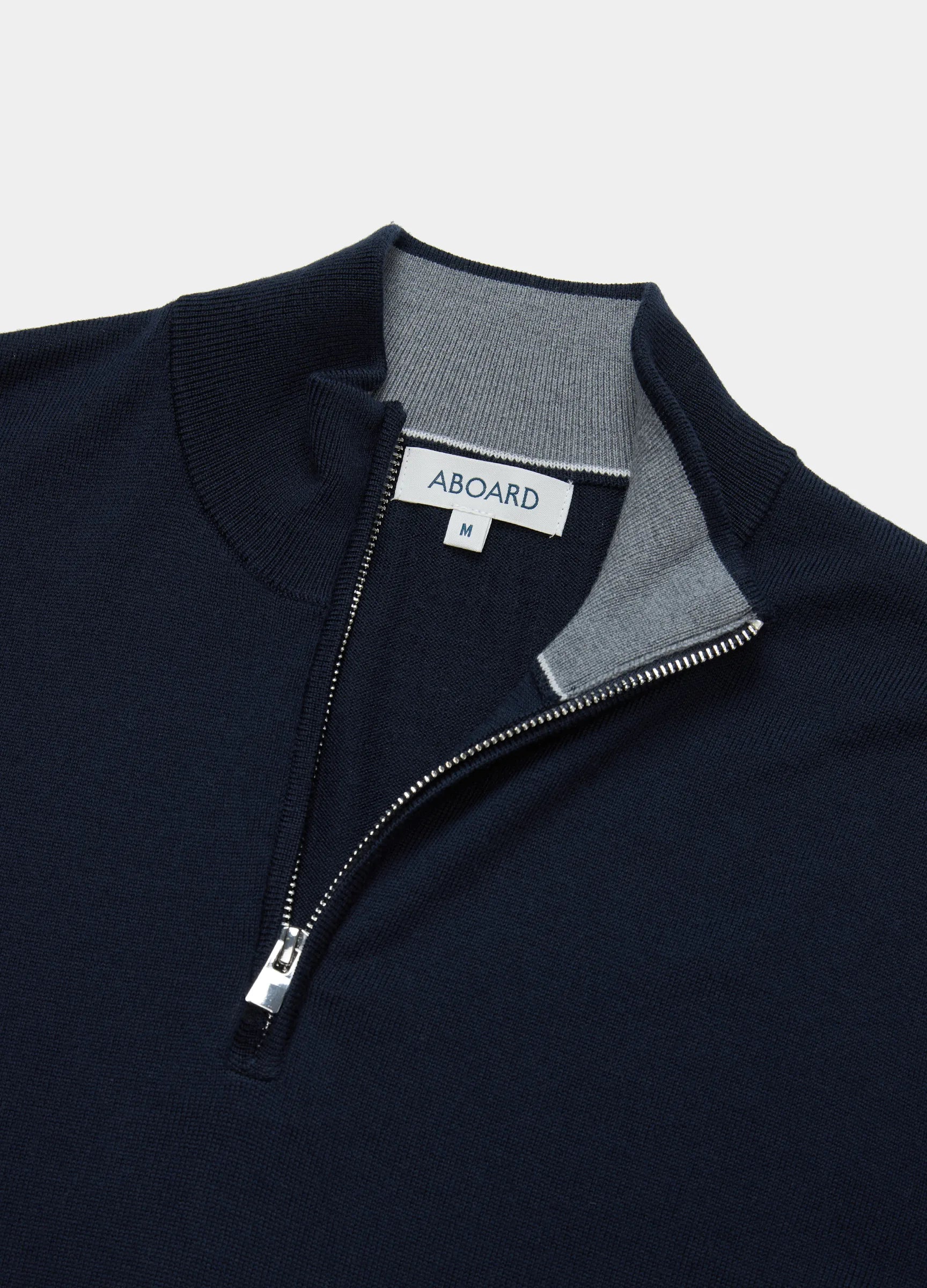 Flat lay of Verbier Merino Travel Quarter Zip in Navy with YKK Zip #color_navy