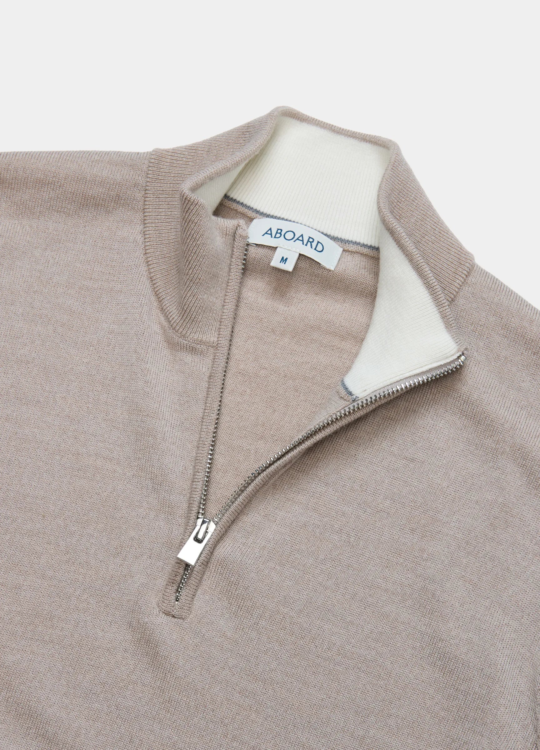 Flat lay of Verbier Merino Travel Quarter Zip in #color_fawn
