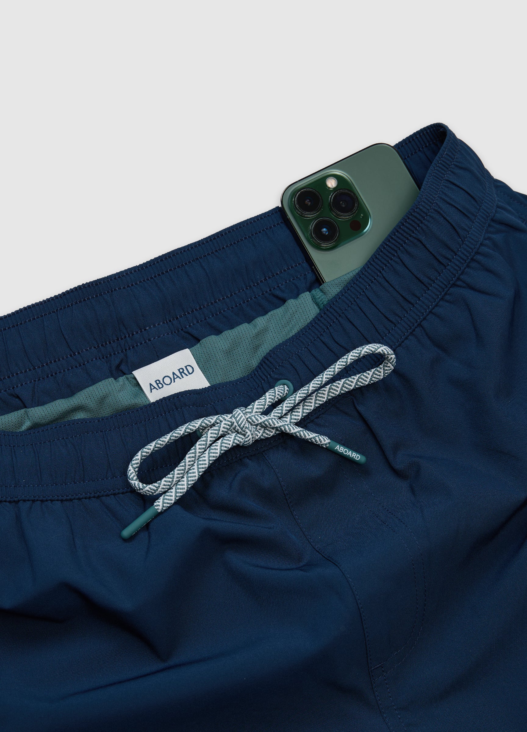 Detail flat lay of ABOARD Travel Flex Swim Short – quick-dry mesh liner with secure phone pocket